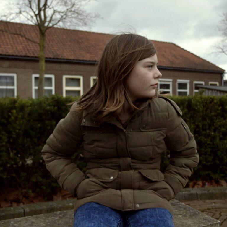 meisje zittend op een schoolplein