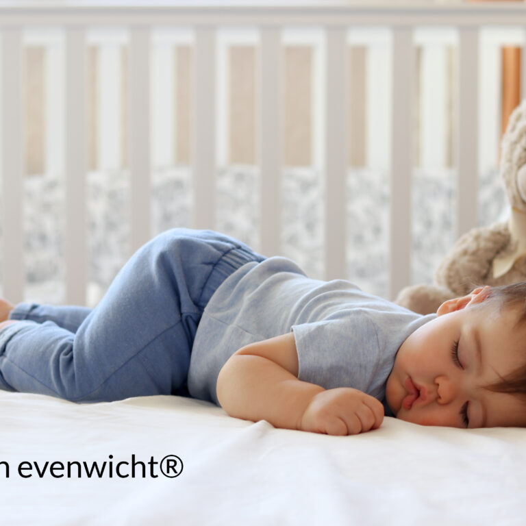 slapend kind in een kinderbedje